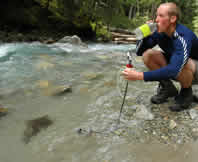 Drinking Purified Water from a Wilderness Stream Drinking Purified Water from a Wilderness Stream